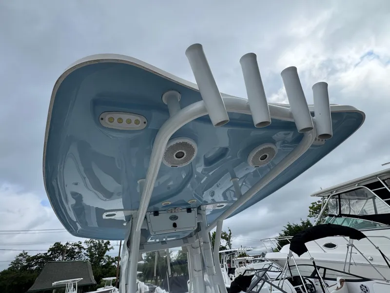 Slide: The Image of 2017 Tidewater 230 CC Adventure boat's T-top with rod holders and speakers. - 5