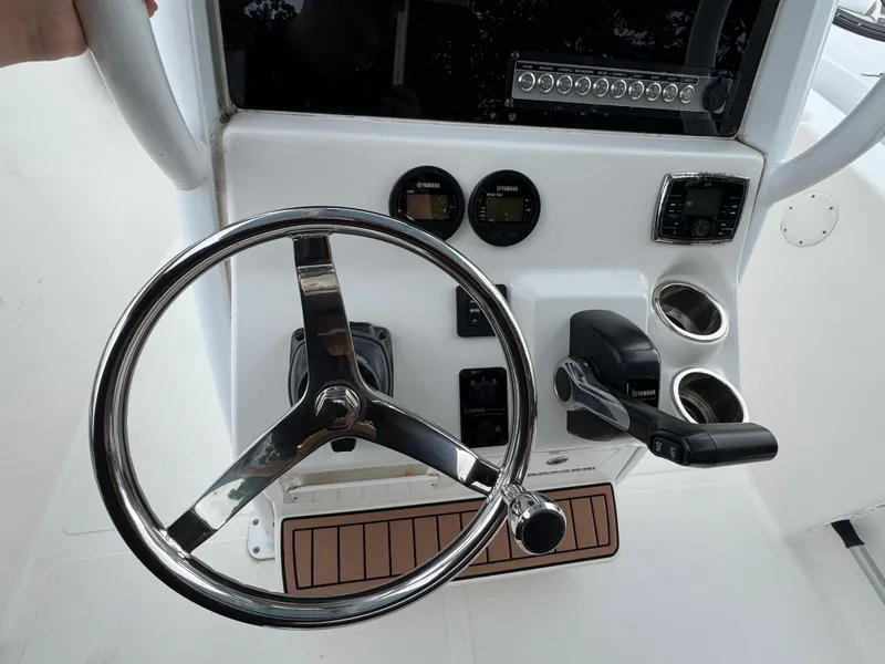 Slide: The Image of Steering console of 2017 Tidewater 230 CC Adventure boat with controls and gauges. - 9