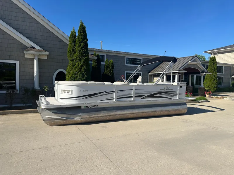 The Image of 2007 Crest 22 II LM pontoon boat parked outside a building on a sunny day. - 1