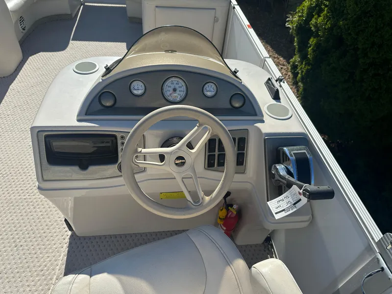 Slide: The Image of Steering console of a 2007 Crest 22 II LM boat with gauges and controls. - 11