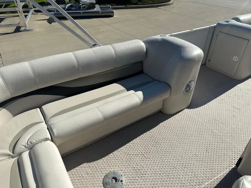 Slide: The Image of 2007 Crest 22 II LM pontoon boat interior with beige seating and carpeted floor. - 12