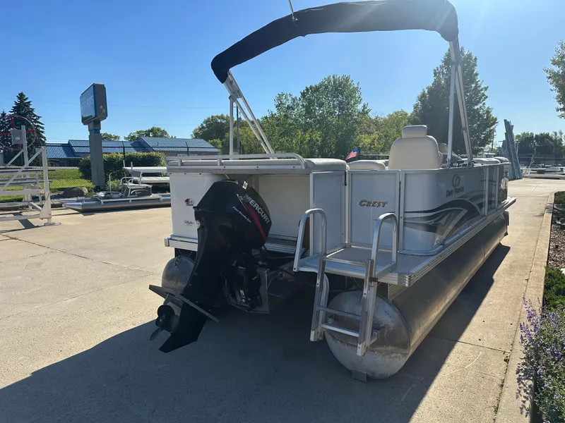 Slide: The Image of 2007 Crest 22 II LM pontoon boat with Mercury outboard motor, parked outdoors. - 14