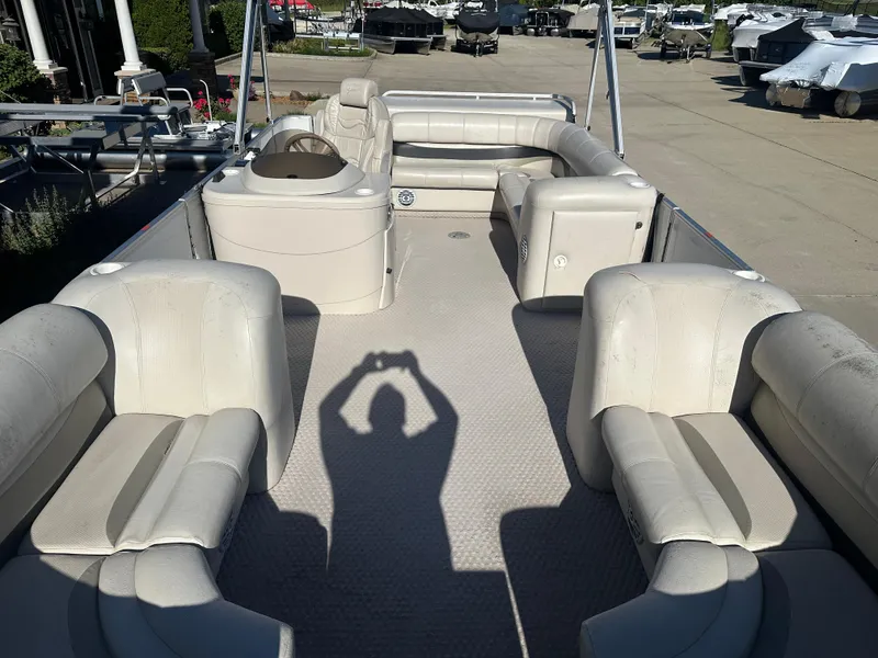 Slide: The Image of 2007 Crest 22 II LM pontoon boat interior with beige seating and shadow on deck. - 2
