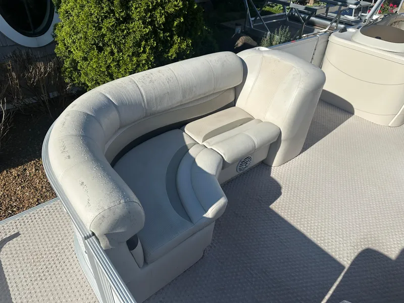 Slide: The Image of 2007 Crest 22 II LM boat interior with white cushioned seating and carpeted floor. - 4