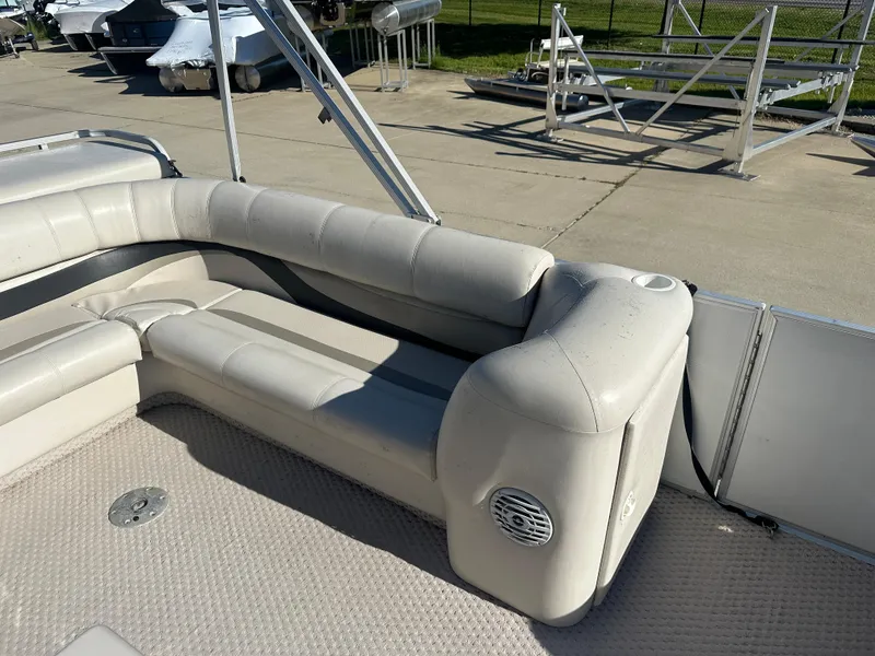 Slide: The Image of 2007 Crest 22 II LM pontoon boat with beige seating and speaker on deck. - 7