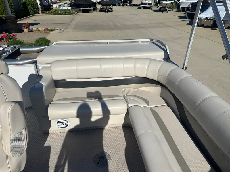 Slide: The Image of 2007 Crest 22 II LM pontoon boat interior with beige seating and shadow on deck. - 8