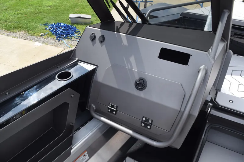 Slide: The Image of Stabicraft 2050 Treker Sportfish 2026 dashboard with cup holder and storage compartment. - 10