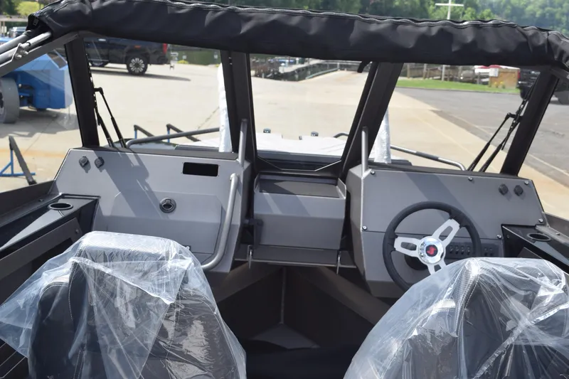 Slide: The Image of Interior view of 2026 Stabicraft 2050 Treker Sportfish boat with covered seats and steering wheel. - 19