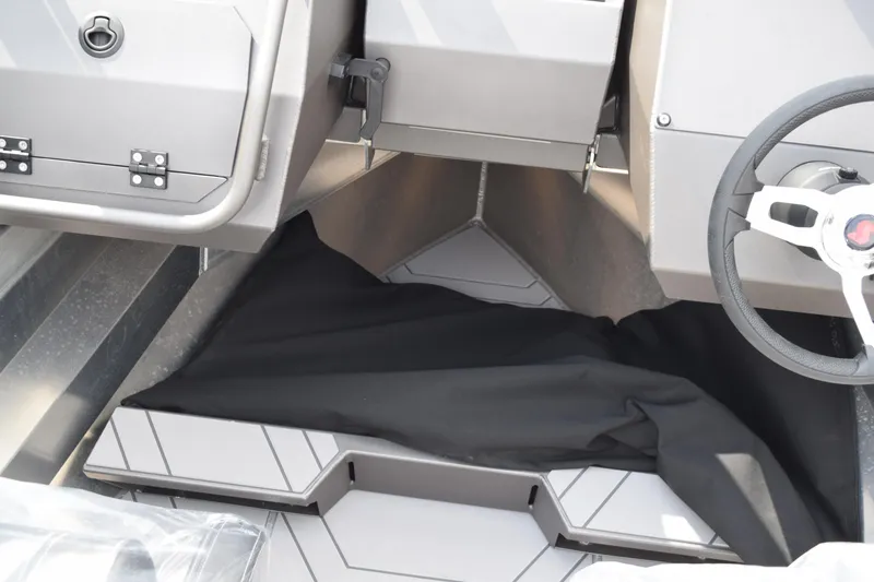 Slide: The Image of Interior of 2026 Stabicraft 2050 Treker Sportfish, featuring steering wheel and storage area. - 20
