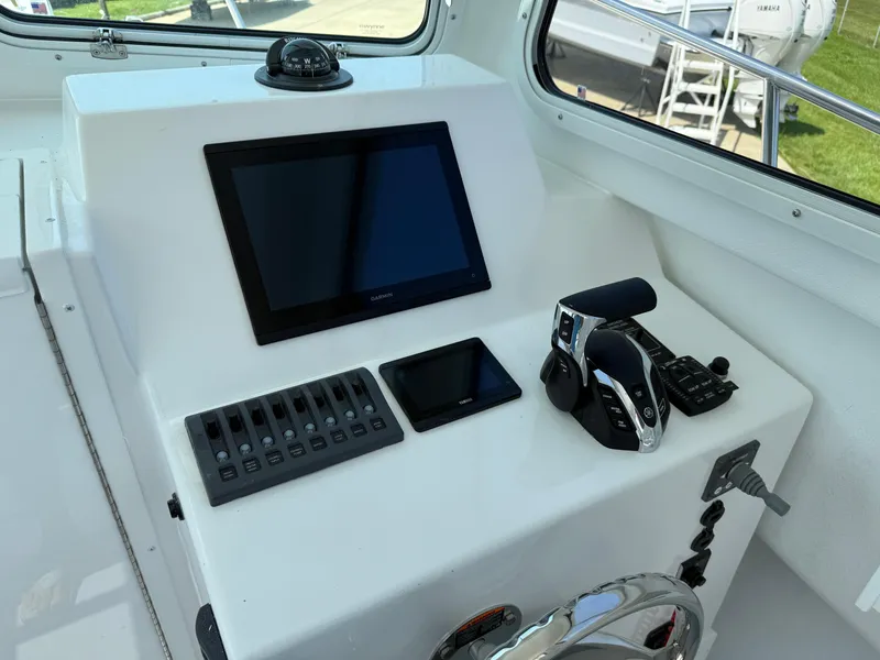 Slide: The Image of Steiger Craft 255 Miami 2026 dashboard with navigation controls and display screens. - 10