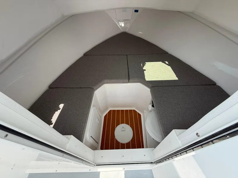 Slide: The Image of 2026 Steiger Craft 255 Miami cabin interior with cushioned seating and wooden flooring. - 12