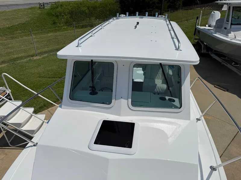 Slide: The Image of 2026 Steiger Craft 255 Miami boat, top view, showcasing cabin and deck details. - 16