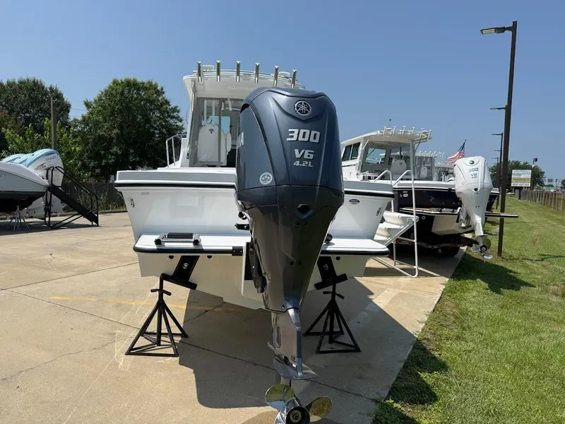 Slide: The Image of 2026 Steiger Craft 255 Miami boat with Yamaha 300 V6 engine displayed outdoors. - 2