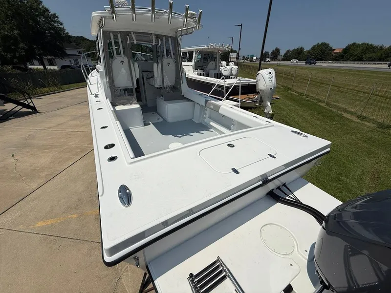 Slide: The Image of 2026 Steiger Craft 255 Miami boat, docked outdoors, showcasing spacious deck and seating area. - 3