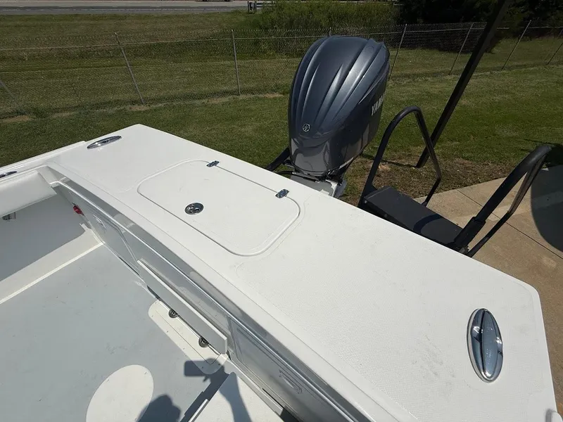 Slide: The Image of 2026 Steiger Craft 255 Miami boat deck with Yamaha outboard motor, parked on grass. - 4