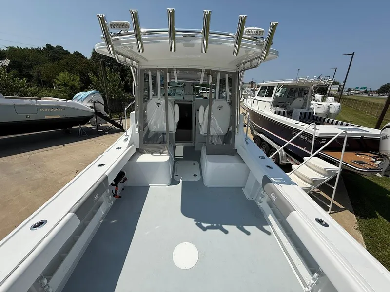 Slide: The Image of 2026 Steiger Craft 255 Miami boat, spacious deck, modern design, docked outdoors. - 7