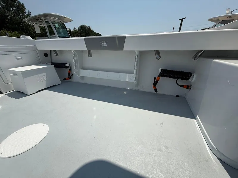 Slide: The Image of 2026 Steiger Craft 255 Miami boat deck, spacious and clean, with storage compartments. - 8