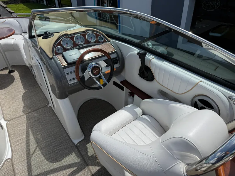 Slide: The Image of 2008 Doral 265 Elite Bowrider interior with steering wheel, gauges, and white seating. - 10