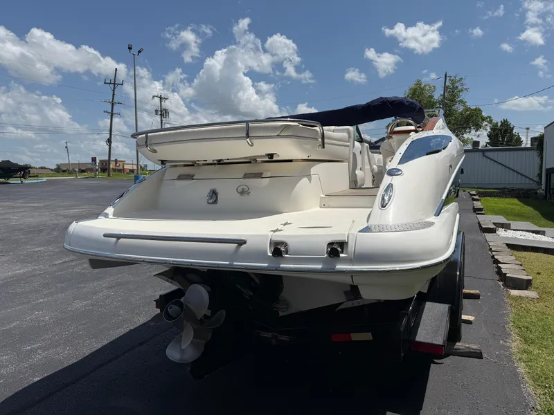 Slide: The Image of 2008 Doral 265 Elite Bowrider boat on trailer under clear sky. - 16
