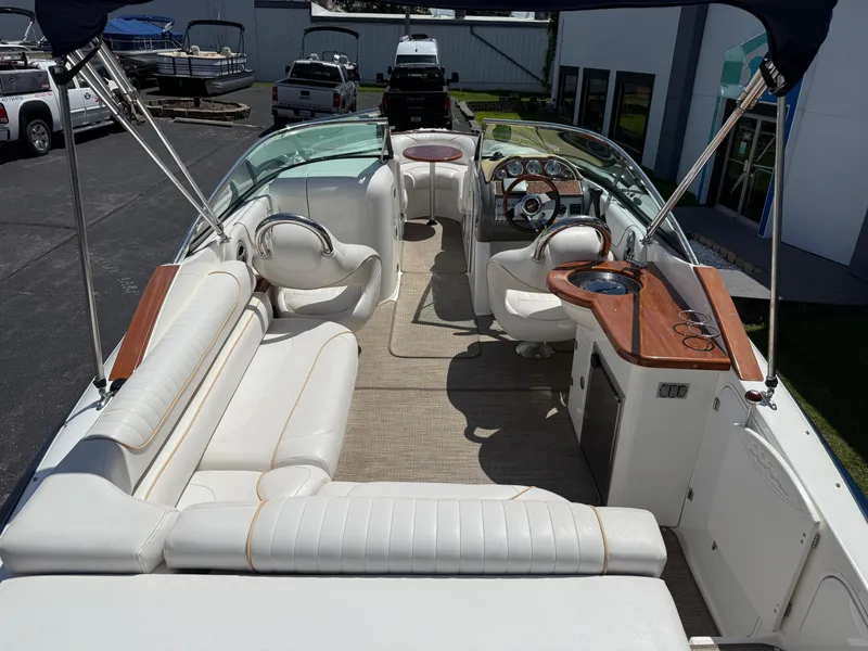 Slide: The Image of 2008 Doral 265 Elite Bowrider interior with white seating and wooden accents. - 4