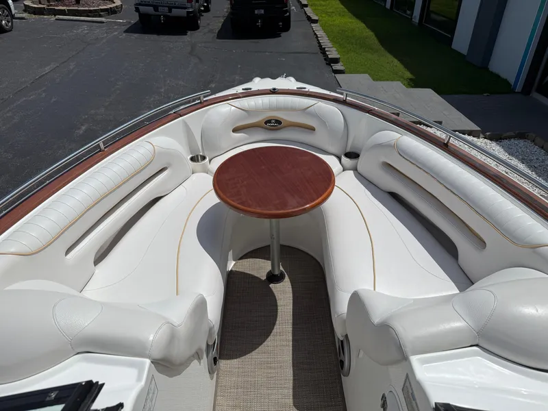 Slide: The Image of 2008 Doral 265 Elite Bowrider interior with white seating and wooden table. - 6