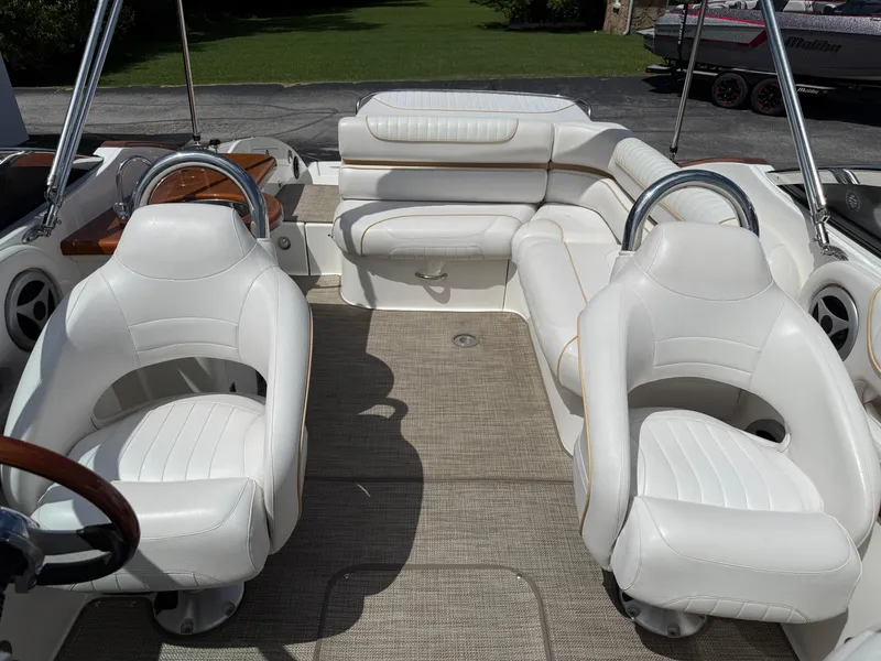 Slide: The Image of 2008 Doral 265 Elite Bowrider interior with white seating and steering wheel. - 7