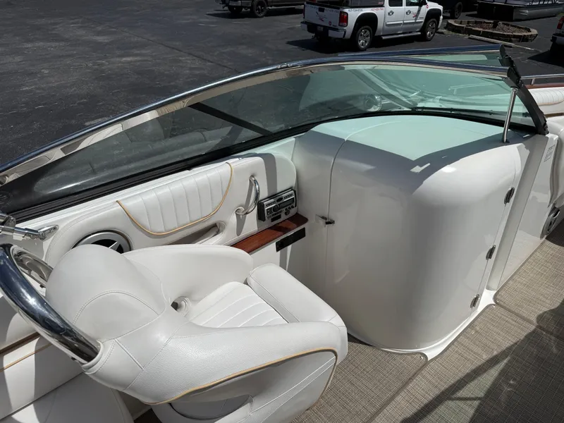 Slide: The Image of 2008 Doral 265 Elite Bowrider interior with white seating and dashboard details. - 8