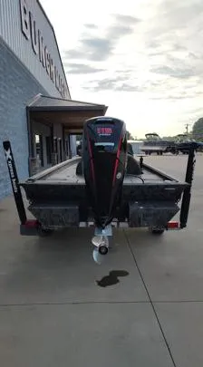 Slide: The Image of 2023 Xpress XP180 boat with motor, parked outside a building. - 11