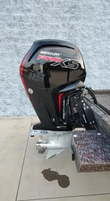 Slide: The Image of 2023 Xpress XP180 boat with Mercury Pro XS outboard motor, parked on concrete. - 12