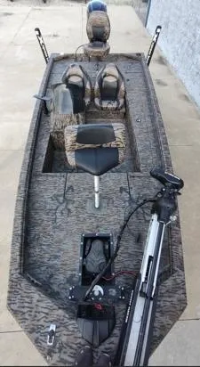 Slide: The Image of 2023 Xpress XP180 boat with camo design, featuring seating and trolling motor. - 6