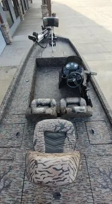 Slide: The Image of 2023 Xpress XP180 boat with camouflage seats and steering console. - 9