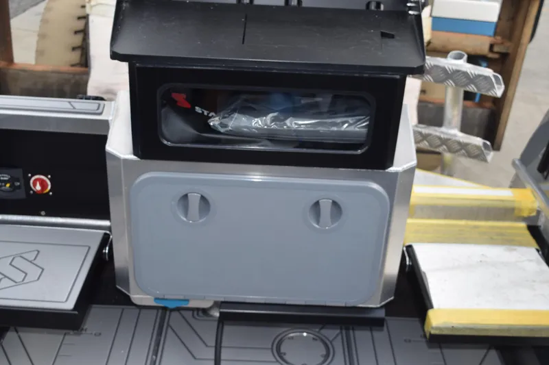 Slide: The Image of 2026 Stabicraft 2050 Supercab Sportfish interior detail with storage compartment and control panel. - 13