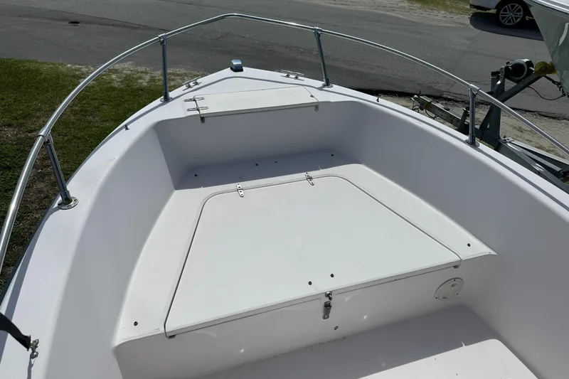 Slide: The Image of 1996 Grady-White Spirit 175 boat interior with storage compartment and railing. - 11