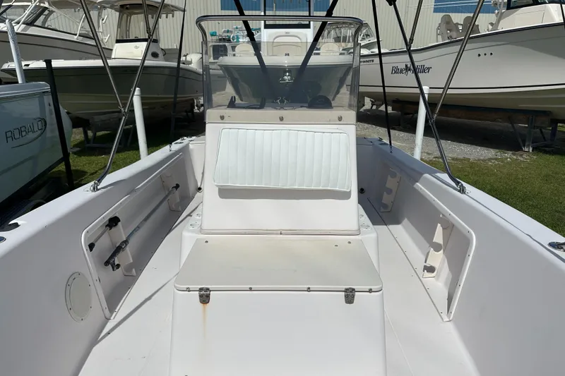 Slide: The Image of 1996 Grady-White Spirit 175 boat interior with seating and console, displayed outdoors. - 14
