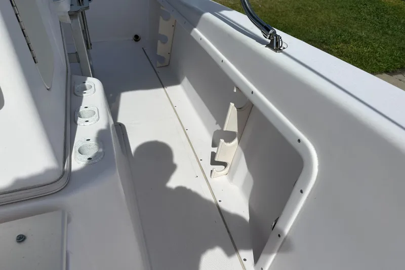 Slide: The Image of 1996 Grady-White Spirit 175 boat interior with rod holders and storage compartments. - 16