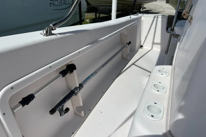 Slide: The Image of 1996 Grady-White Spirit 175 boat interior with rod holders and storage compartment. - 17