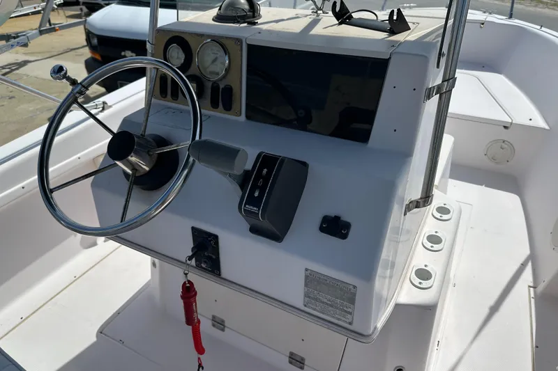 Slide: The Image of 1996 Grady-White Spirit 175 boat console with steering wheel and controls. - 19
