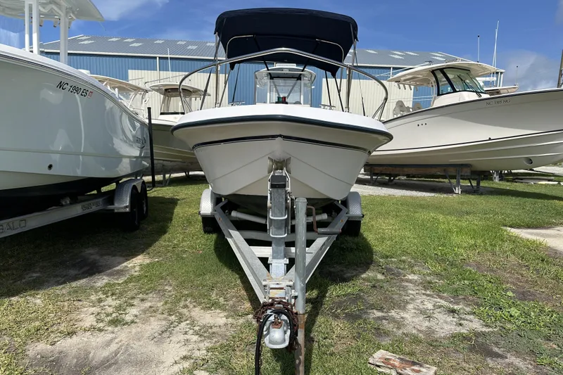 Slide: The Image of 1996 Grady-White Spirit 175 boat on trailer, parked outdoors under blue sky. - 2