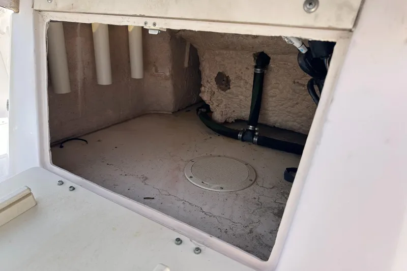 Slide: The Image of Interior compartment of a 1996 Grady-White Spirit 175 boat, showing storage and plumbing. - 20