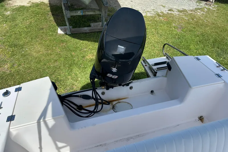 Slide: The Image of 1996 Grady-White Spirit 175 boat with Suzuki 90 outboard motor, parked on grass. - 21