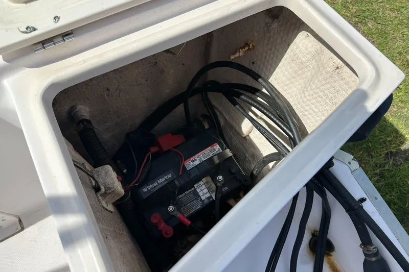 Slide: The Image of Battery compartment of a 1996 Grady-White Spirit 175 boat with cables and connections. - 23