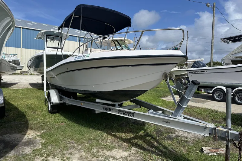Slide: The Image of 1996 Grady-White Spirit 175 boat on trailer, parked outdoors under blue sky. - 3