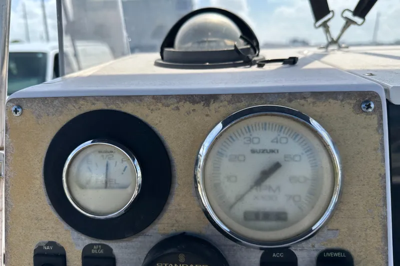 Slide: The Image of 1996 Grady-White Spirit 175 dashboard with Suzuki gauges and controls. - 9