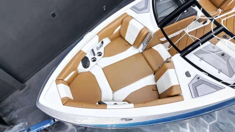 Slide: The Image of 2022 Malibu Wakesetter 25 LSV boat interior with tan and white seating. - 10