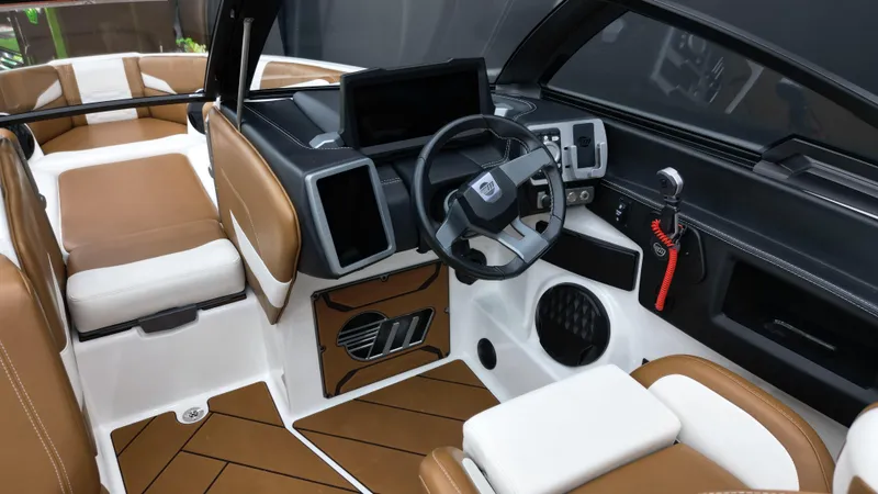 Slide: The Image of 2022 Malibu Wakesetter 25 LSV interior with modern dashboard and brown leather seating. - 11