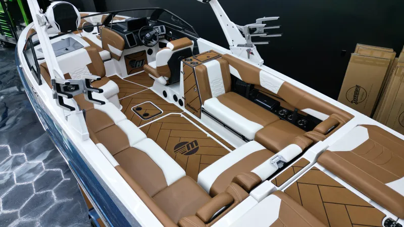 Slide: The Image of 2022 Malibu Wakesetter 25 LSV interior with brown and white seating, modern dashboard, and spacious layout. - 14