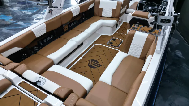 Slide: The Image of 2022 Malibu Wakesetter 25 LSV interior with luxurious brown and white seating. - 15