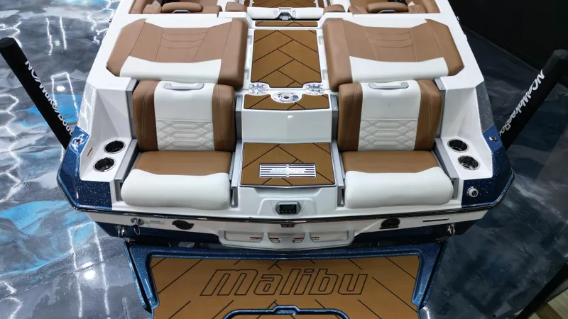 Slide: The Image of 2022 Malibu Wakesetter 25 LSV boat interior with brown and white seating. - 20