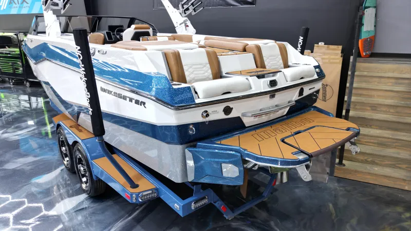 Slide: The Image of 2022 Malibu Wakesetter 25 LSV boat on trailer, showcasing sleek design and luxury features. - 21