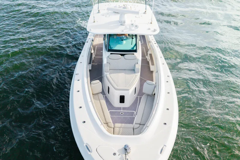Slide: The Image of 2023 HCB 42 Lujo boat on water, aerial view showcasing sleek design and spacious deck. - 13